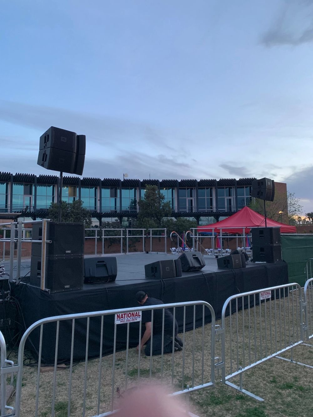 Audience view of a lit stage with LED screen backdrop