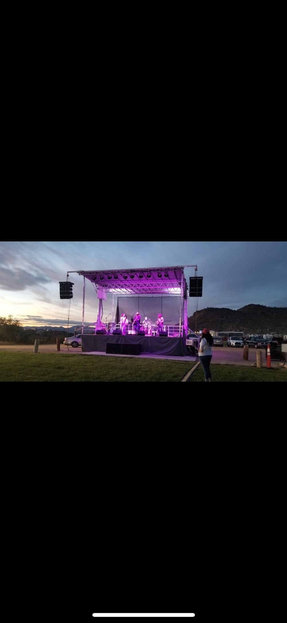 Stage lit in deep purple with LED video wall